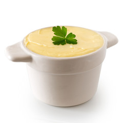 Round ceramic dish filled with butter isolated on white. Parsley garnish.