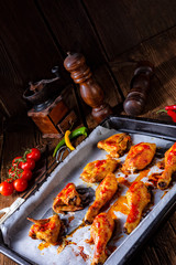 Rustic backed chicken wings,legs on baking tray