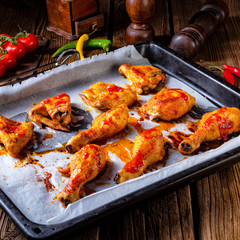Rustic backed chicken wings,legs on baking tray
