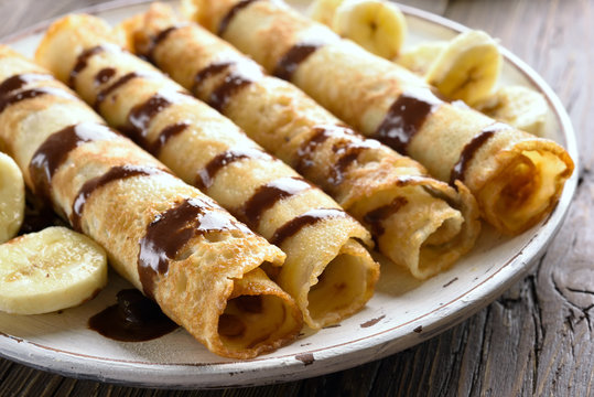 Delicious crepe roll with banana slices