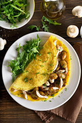 Omelette with mushrooms, chicken meat, greens