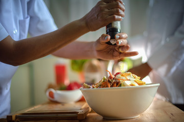 assorted vegetable salad eggs topping by scatter over of pepper and thyme leaf powder, hand of chef prepare cooking ready to serving in new and always fresh