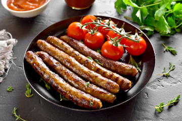 Roasted sausages and cherry tomatoes