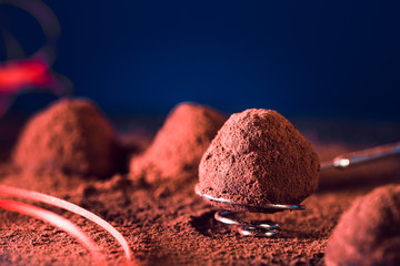Chocolate truffles and gift bow . delicious homemade truffle. dark chocolate and cocoa powder....