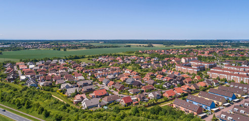 Fototapeta na wymiar Aerial view of a suburb on the outskirts of Wolfsburg in Germany, with terraced houses, semi-detached houses and detached houses