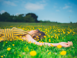 Young woman lying in meadow