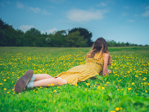 Young woman lying in meadow