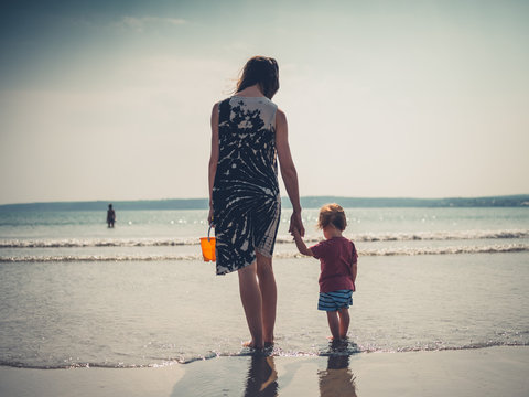 Young mother with little boy at the beach