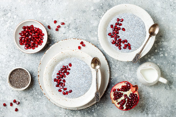 Healthy breakfast set. Chia seed pudding bowls with pomegranate.