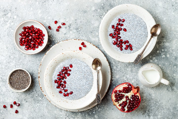 Obraz na płótnie Canvas Healthy breakfast set. Chia seed pudding bowls with pomegranate.