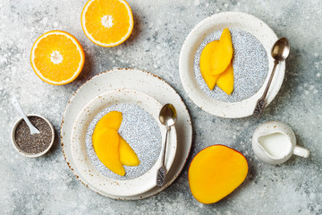 Healthy breakfast set. Chia seed pudding bowls with mango.