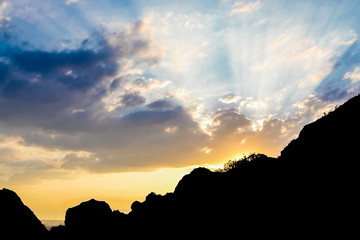 Amazing landscape of Mountain Sunset. Beautiful rays of the Sun against the Sky with colorful clouds.