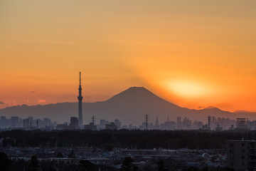 .Tokyo Fuji diamond with Tokyo Skytree landmark.  Diamond Fuji is View of the setting sun meeting the summit of Mt. Fuji