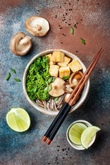 Obraz na płótnie Canvas Miso and soba noodles soup with kale, shiitake mushrooms, .roasted tofu