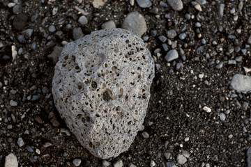 volcanic stone on black sand