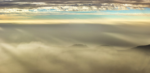 sunrise from teide volcano with transparent fog above mountains