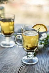 Fresh green tea. Tea cup with green tea leaf on the wooden table. Tea with lemon