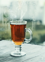 Fresh green tea. Tea cup with green tea leaf on the wooden table. Tea with lemon