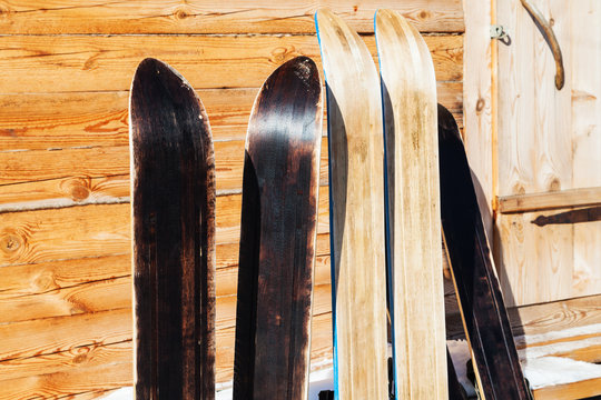 wide hunting skis near door of wooden cottage