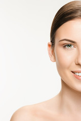 Fototapeta premium Beautiful face of young adult woman with clean fresh skin isolated on white