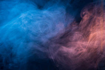 Obraz na płótnie Canvas Abstract blue and pink smoke on a dark background