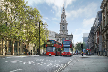 London street with buses and the Saint Mary-le-Strand Church.