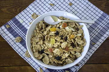 A bowl full of muesli cereals with spoon