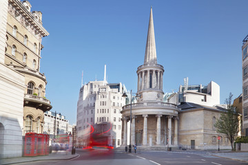 London street with blurred buses and the All Souls Langham Place.