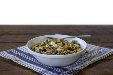A bowl full of muesli cereals with spoon