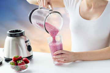 healthy eating, cooking, dieting and people concept - close up of woman with blender and...