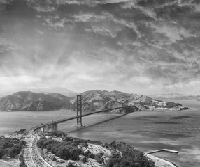 Aerial overhead view of San Francisco Golden Gate Bridge and city traffic from helicopter
