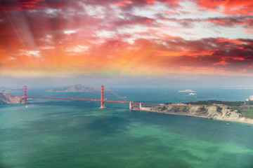 Aerial view of San Francisco Golden Gate Bridge and city hills from helicopter