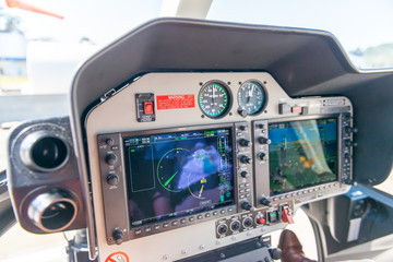 Helicopter cockpit and technology. Copter dashboard with displays, dials, buttons and switches