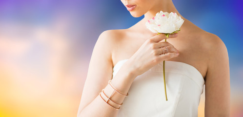 beauty, jewelry and luxury concept - close up of beautiful woman with golden ring and bracelet...