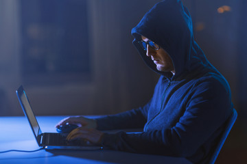 cybercrime, hacking and technology crime - male hacker in dark room using laptop computer for cyber attack © Syda Productions