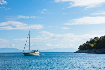 Fototapeta na wymiar Sailboats at Limnonary bay, sunny morning at Skopelos island, Greece