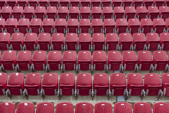 Picture of red colored tennis chairs in the line