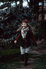 Young girl walking in the Park. Laughter, smile, style, Fashion.