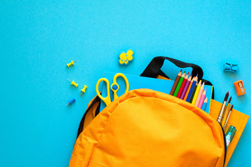 Back to school concept. Backpack with school supplies. Top view. Copy space