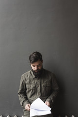 Portrait of a young man reading paperwork