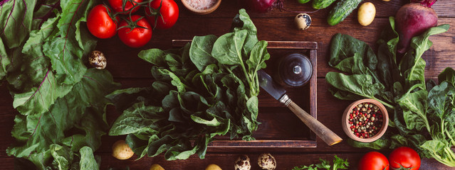 spinach in a box, fresh vegetables, wooden background, banner
