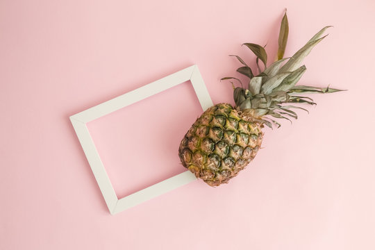 Pineapple and photo frame tropical abstract concept.