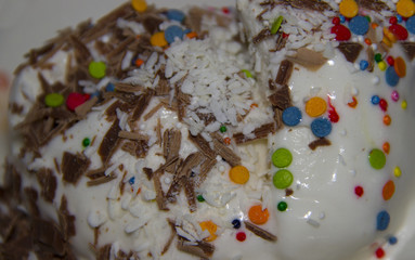 ice cream sprinkled with colored chocolate and coconut shavings