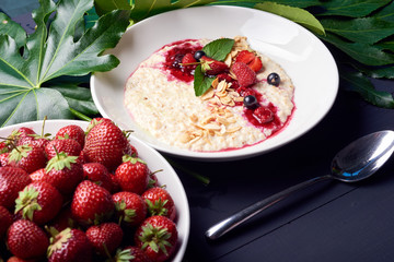 Oatmeal with strawberries. Summer breakfast healthy and tasty.