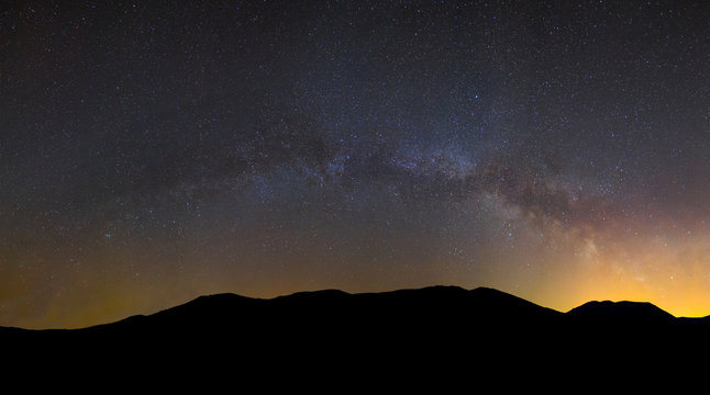 mountain chain silhouette  under a milky way