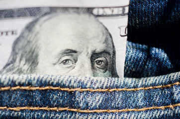 Hundred dollar bill in pocket of blue jeans