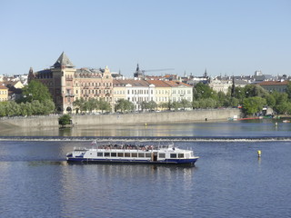 Fototapeta na wymiar View of the Vltava River. Bridge over the Vltava River. The ship sails by Vltava River.