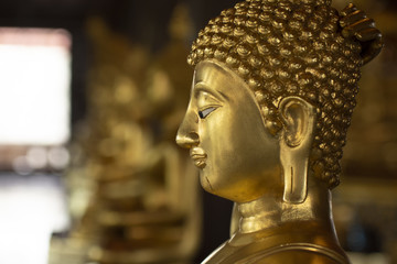 Golden Buddha images in different attitudes sculpture at Wat Krathum Suea Pla temple ,Bangkok
