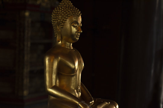 Golden Buddha images in different attitudes sculpture at Wat Krathum Suea Pla temple ,Bangkok
