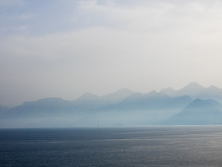 Naklejka na ściany i meble Breathtaking misty mountains view from Antalya, Turkey.